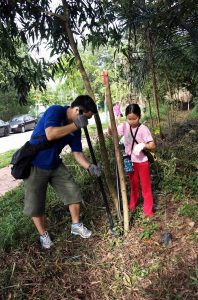 Keith Chew and his daughter planting a tree together